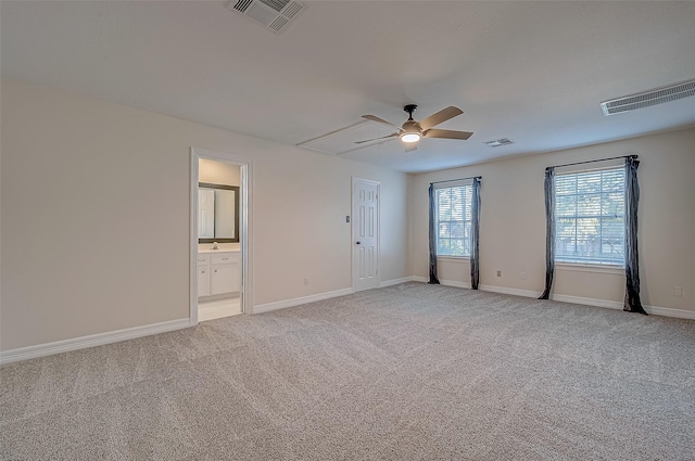 unfurnished room with baseboards, visible vents, and light colored carpet