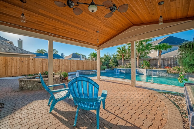 view of patio / terrace with a fenced backyard, a pool with connected hot tub, and ceiling fan