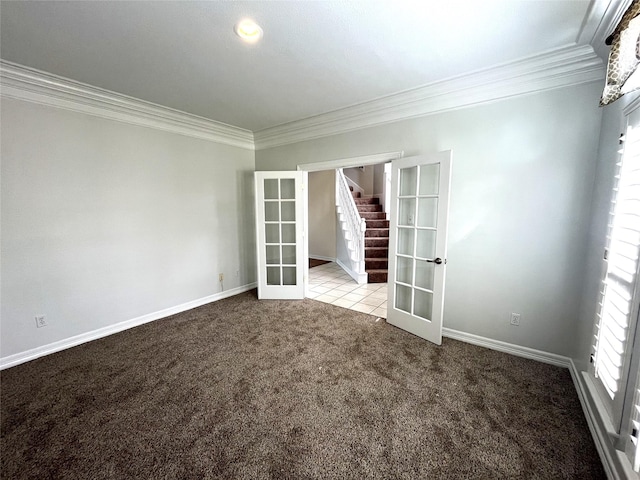 spare room featuring ornamental molding, french doors, light colored carpet, and baseboards