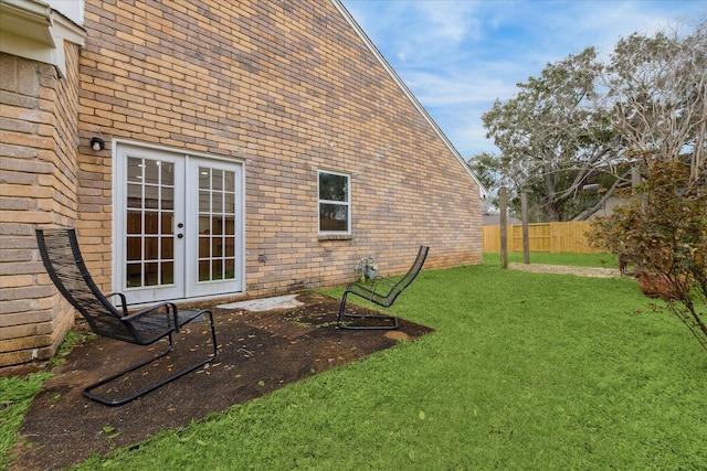 view of yard with french doors, a patio area, and fence