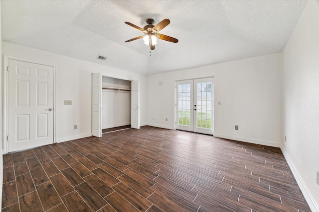 unfurnished bedroom with visible vents, access to exterior, baseboards, french doors, and wood tiled floor