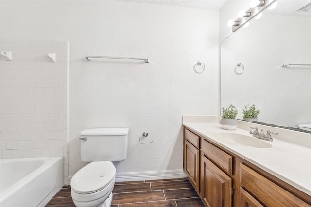 full bathroom with visible vents, toilet, wood tiled floor, vanity, and baseboards