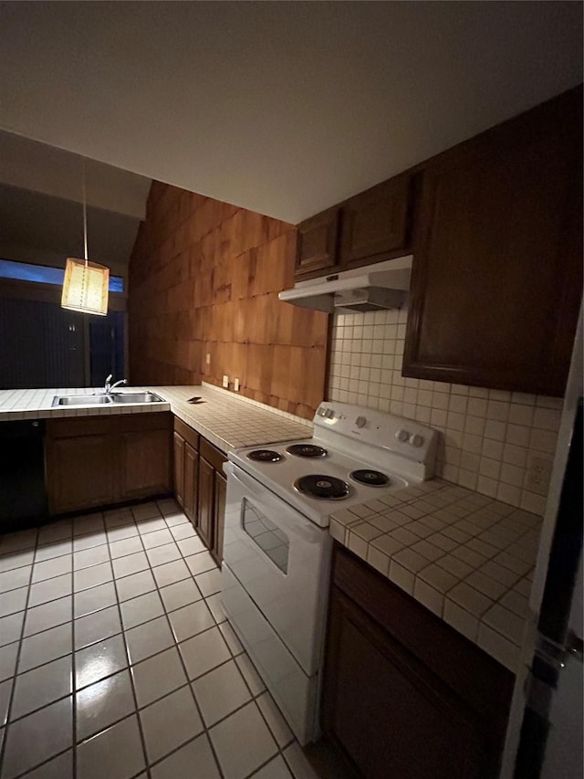 kitchen featuring tile countertops, white electric range oven, tasteful backsplash, a sink, and under cabinet range hood