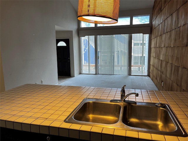 kitchen featuring tile counters and a sink