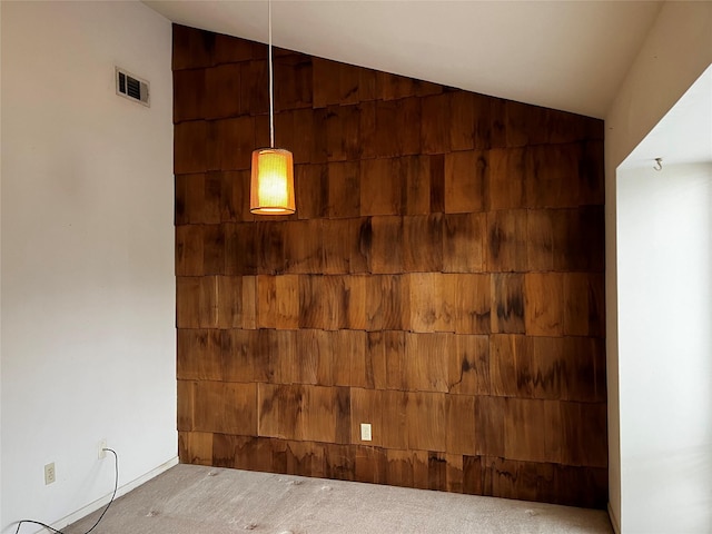 room details with carpet floors, visible vents, and wooden walls