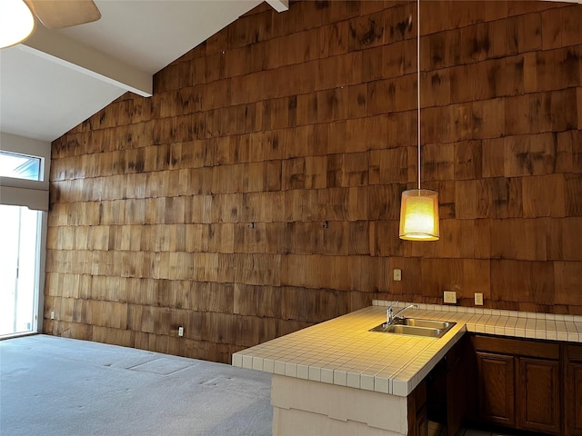 bar featuring lofted ceiling with beams, wood walls, a sink, and carpet flooring