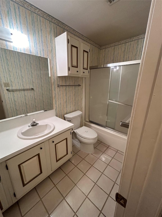 full bath with wallpapered walls, toilet, enclosed tub / shower combo, vanity, and tile patterned floors