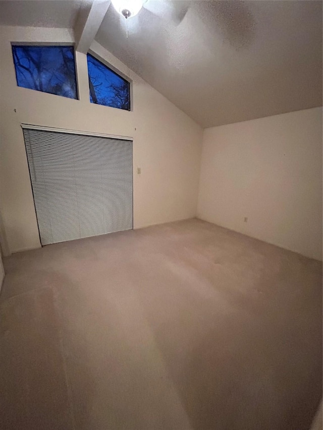 bonus room featuring lofted ceiling with beams and carpet