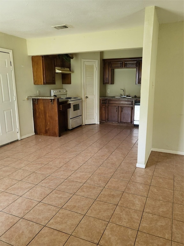 kitchen featuring white electric stove, light countertops, visible vents, a sink, and dishwasher