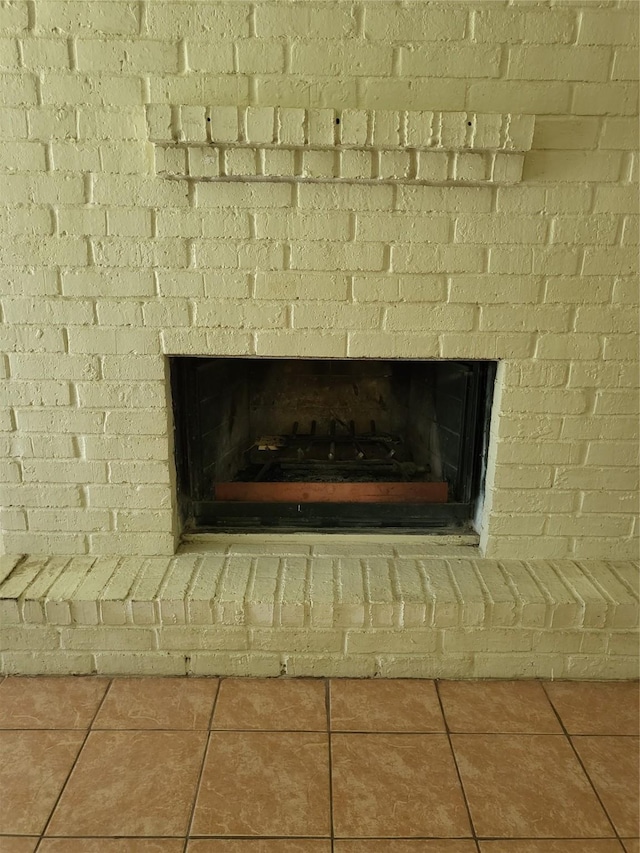 interior details featuring a brick fireplace