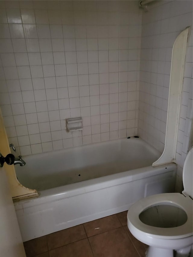 full bathroom with shower / bathtub combination, toilet, and tile patterned floors