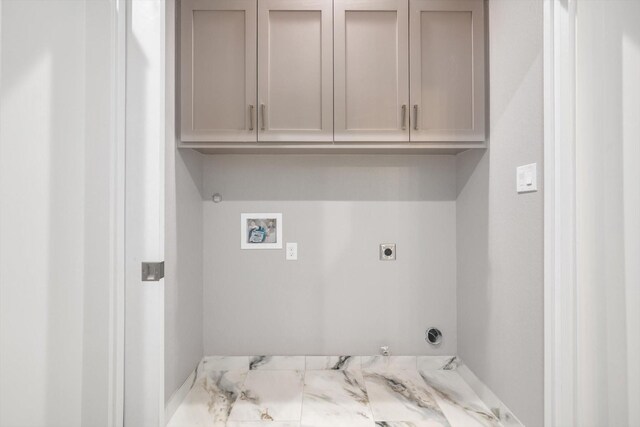 clothes washing area with hookup for a gas dryer, washer hookup, cabinet space, and electric dryer hookup