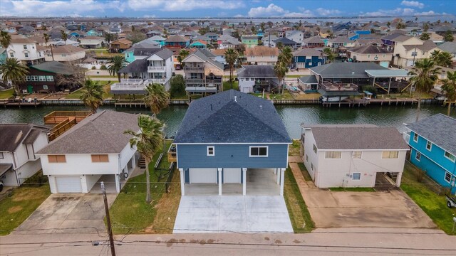 birds eye view of property featuring a residential view and a water view