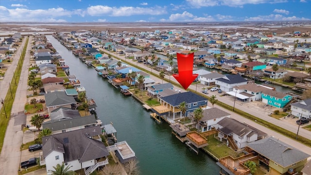 birds eye view of property with a water view and a residential view