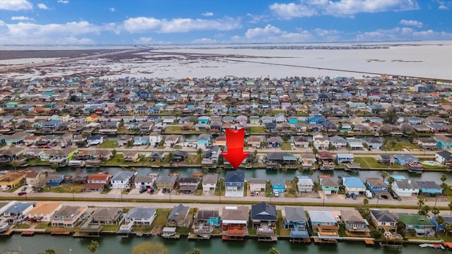 drone / aerial view with a residential view and a water view