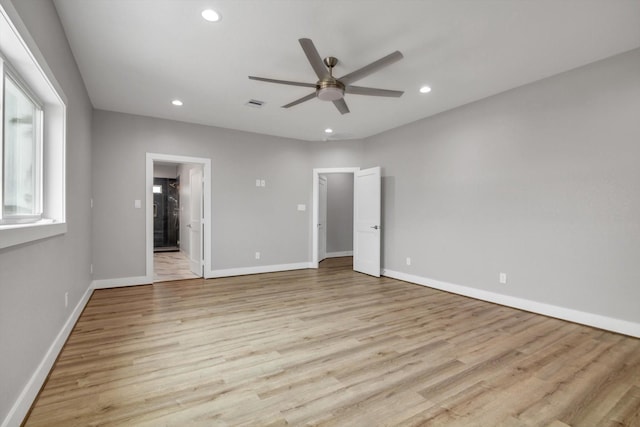 unfurnished bedroom with recessed lighting, baseboards, light wood-style flooring, and ensuite bath