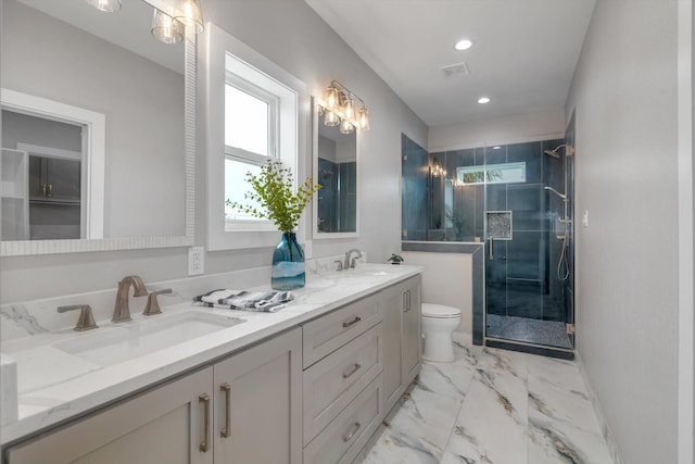bathroom with toilet, marble finish floor, visible vents, and a sink