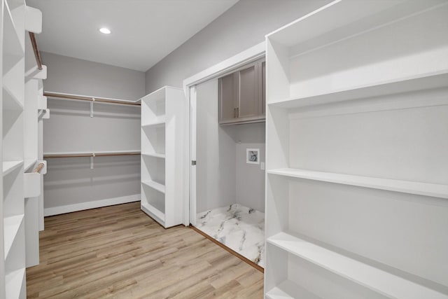 walk in closet with light wood-type flooring