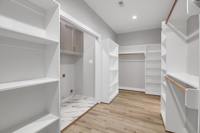spacious closet with visible vents and light wood-style flooring