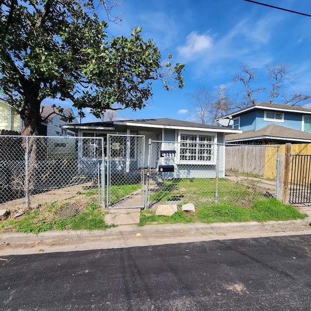 view of front facade featuring a fenced front yard and a gate