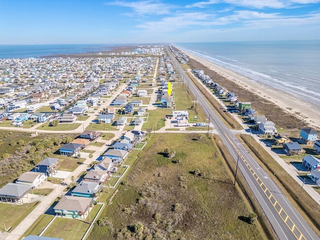 drone / aerial view with a water view, a residential view, and a beach view