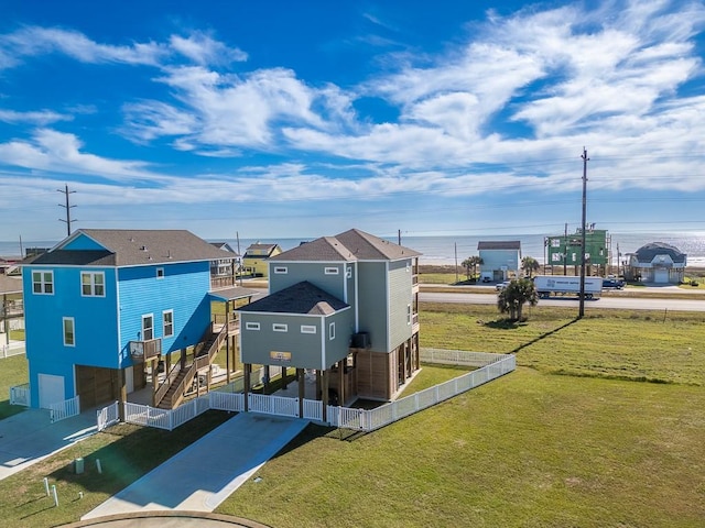 view of home's community featuring a carport, concrete driveway, and fence