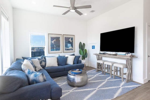 living room with recessed lighting, visible vents, a ceiling fan, wood finished floors, and baseboards