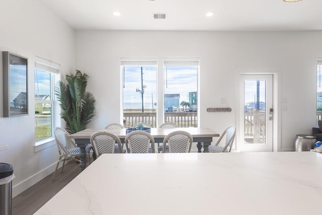 dining space with baseboards, visible vents, dark wood-type flooring, and recessed lighting