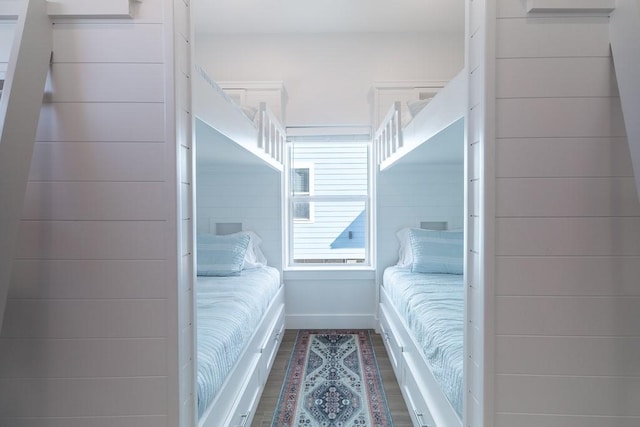 bedroom featuring baseboards and wood finished floors