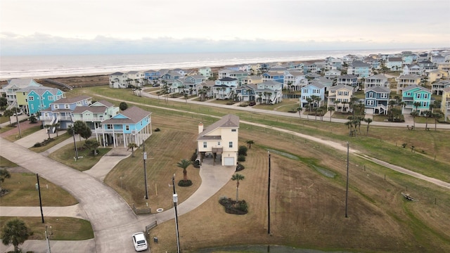 birds eye view of property with a water view, a residential view, and a view of the beach