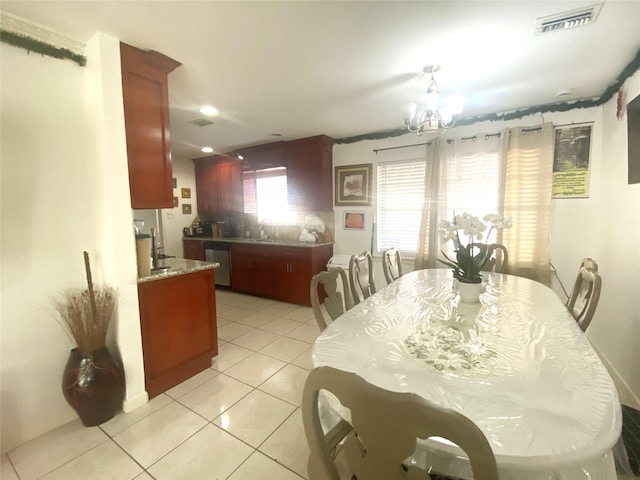 dining area featuring light tile patterned flooring, visible vents, and an inviting chandelier