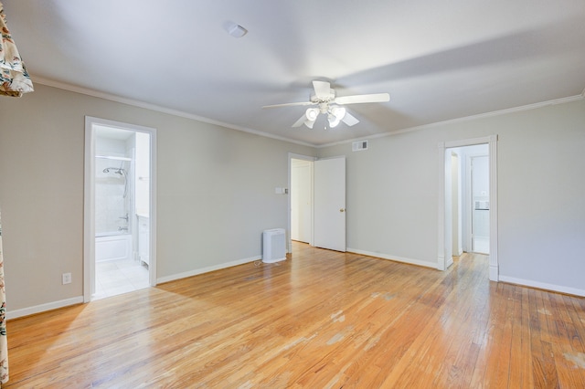 empty room with a ceiling fan, visible vents, baseboards, ornamental molding, and light wood finished floors