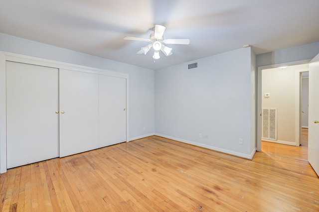 unfurnished bedroom with light wood-style flooring, a closet, visible vents, and baseboards