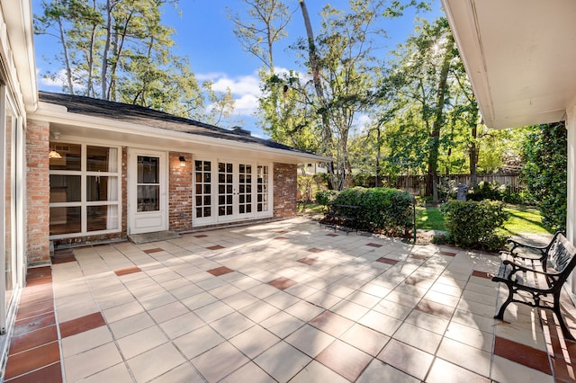 view of patio featuring an outdoor structure and fence