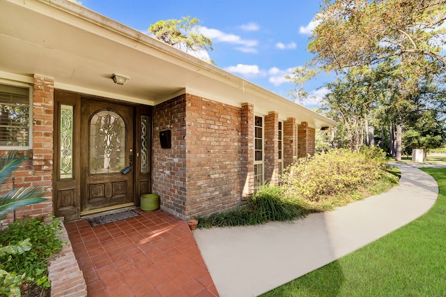 entrance to property with brick siding