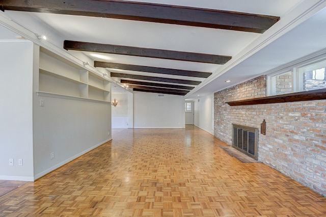 unfurnished living room featuring brick wall, beamed ceiling, a fireplace, and baseboards