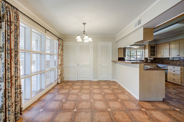 kitchen featuring pendant lighting, a peninsula, visible vents, glass insert cabinets, and crown molding