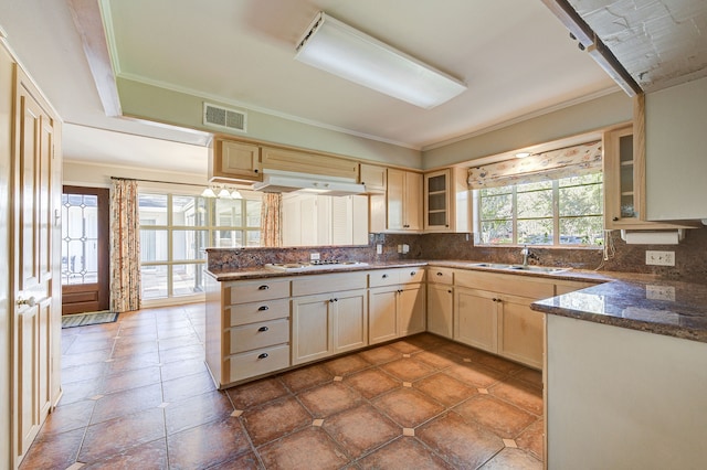 kitchen featuring visible vents, backsplash, and glass insert cabinets