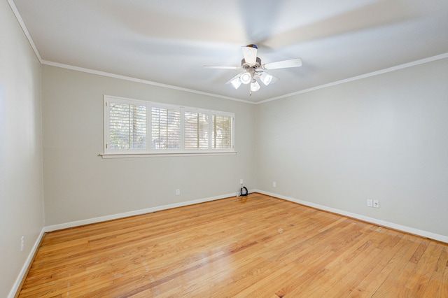 spare room featuring light wood finished floors, baseboards, ornamental molding, and ceiling fan