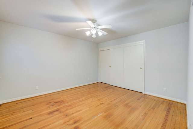 unfurnished bedroom with light wood-style floors, a closet, ceiling fan, and baseboards