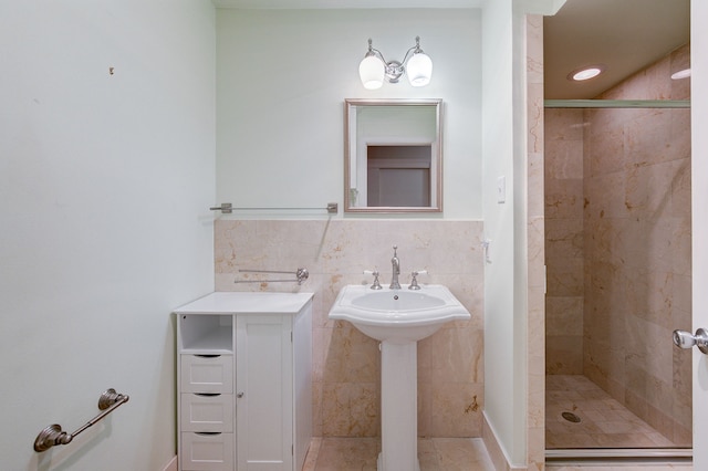 bathroom featuring a shower stall and tile walls