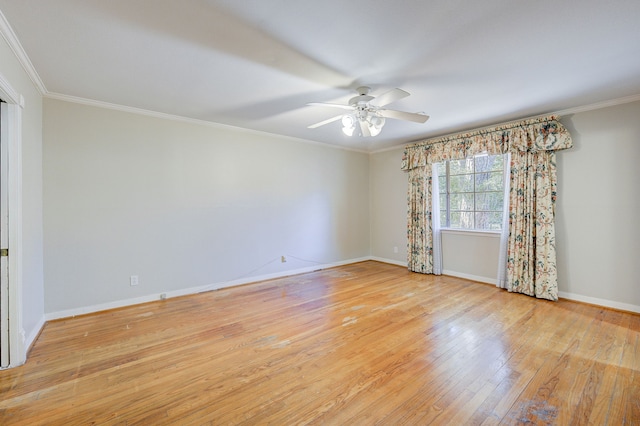 spare room featuring ornamental molding, light wood-style flooring, baseboards, and a ceiling fan