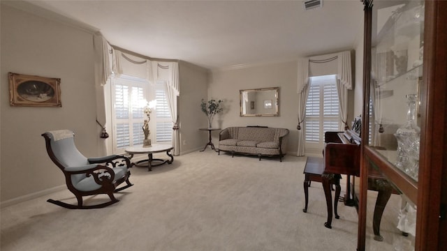 living area with ornamental molding, light carpet, plenty of natural light, and visible vents