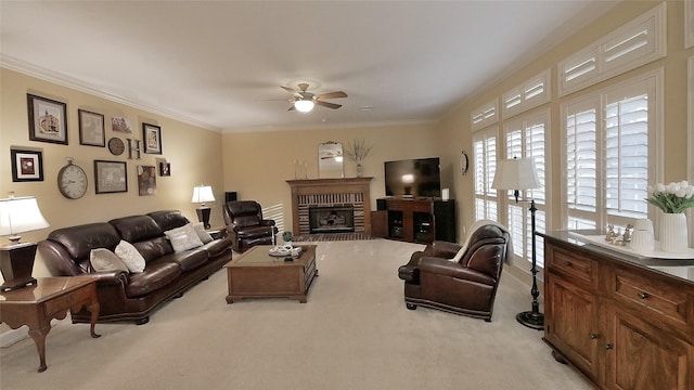 living room featuring light carpet, ceiling fan, a fireplace, and crown molding