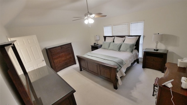 bedroom with lofted ceiling, light colored carpet, and ceiling fan