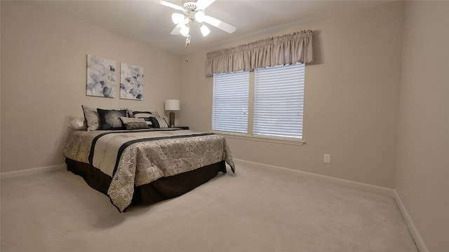 bedroom with ceiling fan, carpet, and baseboards