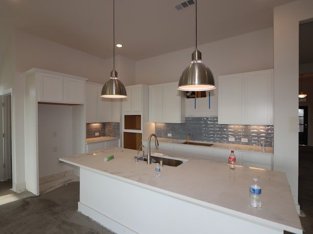 8311 Oceanmist Cove Dr, Cypress, TX 77433 - kitchen featuring a sink, an island with sink, white cabinetry, decorative backsplash, and recessed lighting