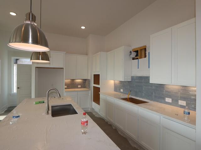 8311 Oceanmist Cove Dr, Cypress, TX 77433 - kitchen with a sink, tasteful backsplash, white cabinetry, light stone countertops, and recessed lighting