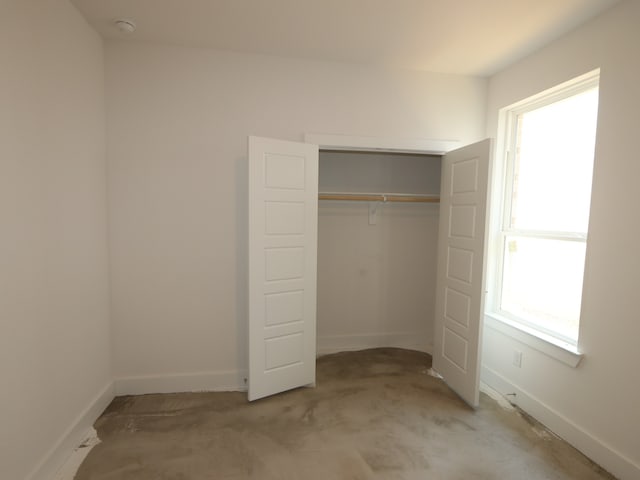 8311 Oceanmist Cove Dr, Cypress, TX 77433 - unfurnished bedroom featuring multiple windows, baseboards, and a closet