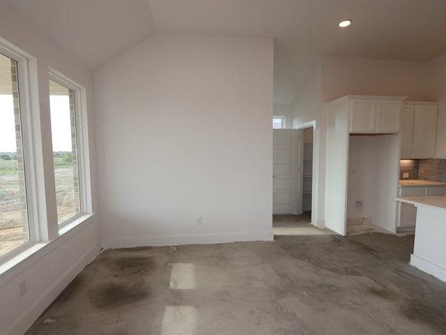 8311 Oceanmist Cove Dr, Cypress, TX 77433 - unfurnished living room with plenty of natural light, lofted ceiling, baseboards, and recessed lighting